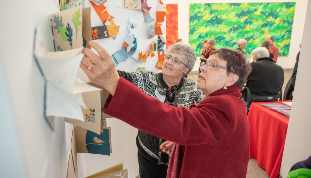 wo participants review artwork at the Eric Carle Museum of Picture Book Art in Massachusetts.