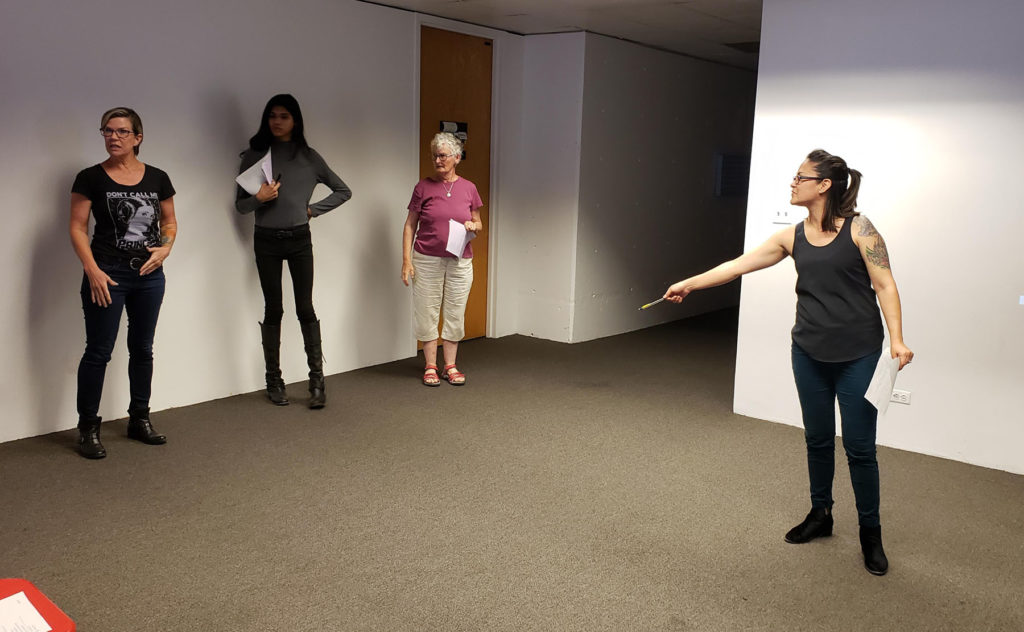 A group of three students of various ages and their instructor in a practice room at MOCA Tucson